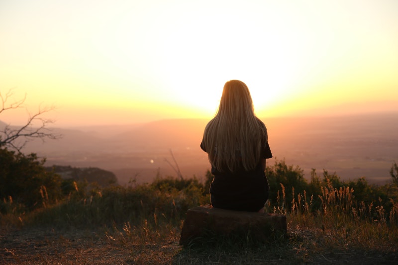 Woman alone watching the sunrise